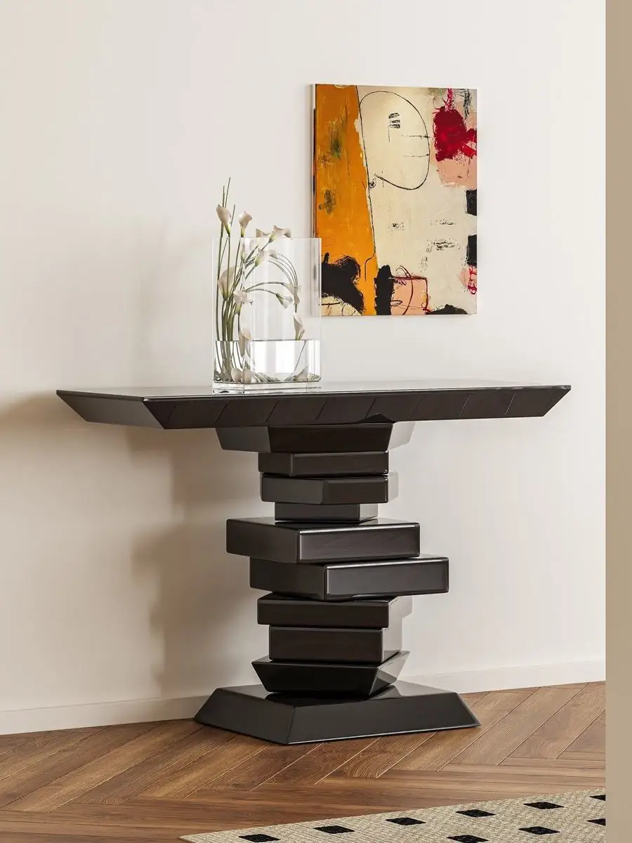 sculptural stacked-volume console table presented in a styled residential interior