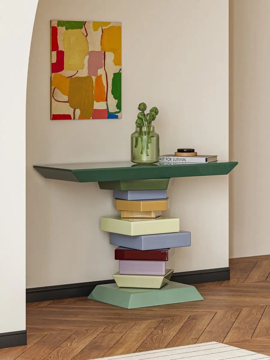 sculptural stacked-volume console table shown in a second interior setting