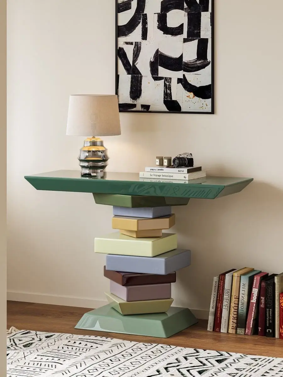 sculptural stacked-volume console table shown with surrounding furniture for scale
