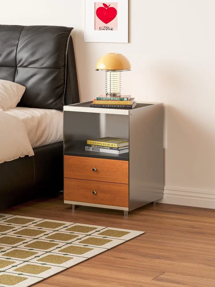 Nightstand staged beside a bed with coloured lighting accents
