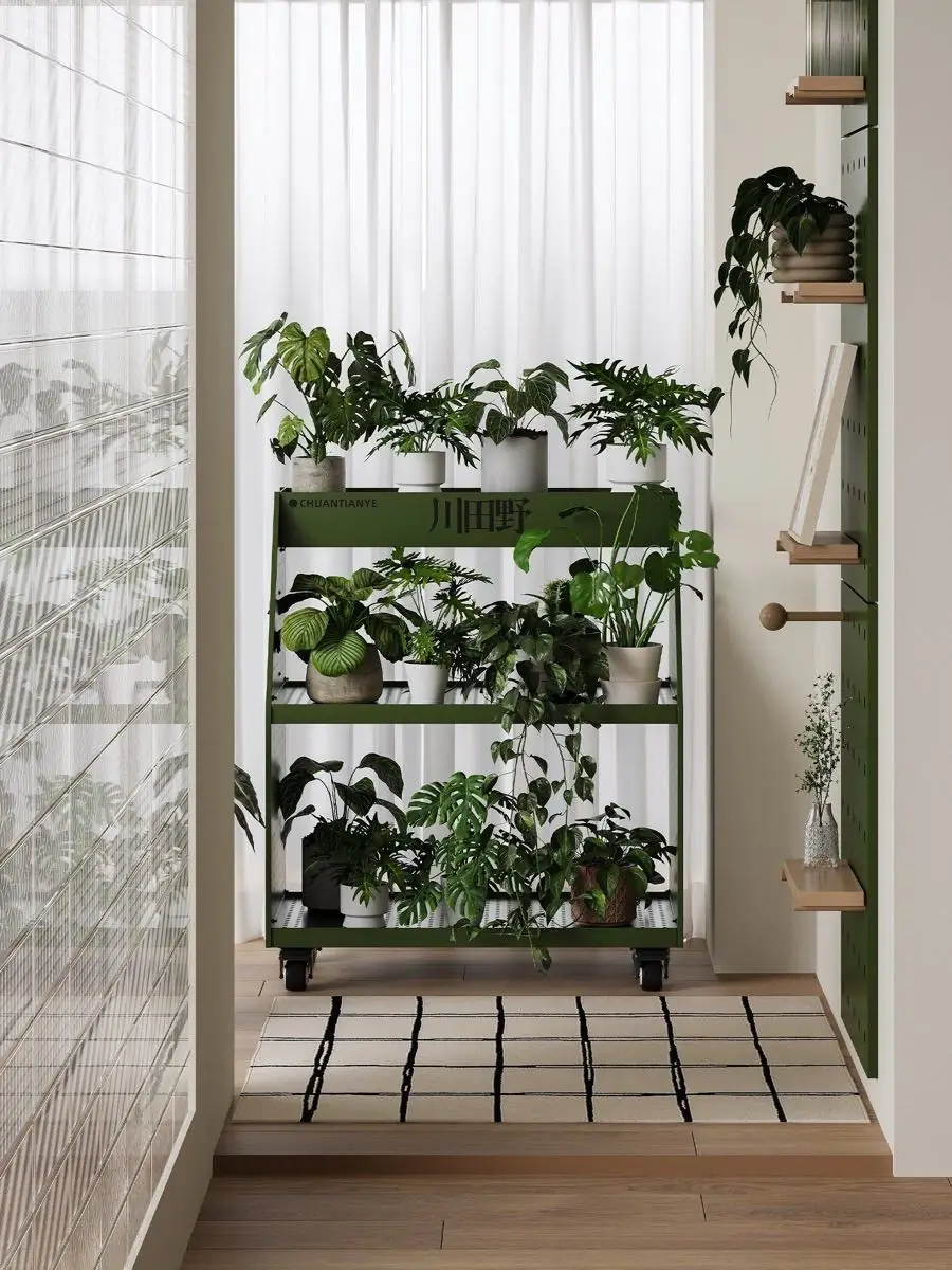 Green mobile plant trolley staged beside glass blocks and a bright window