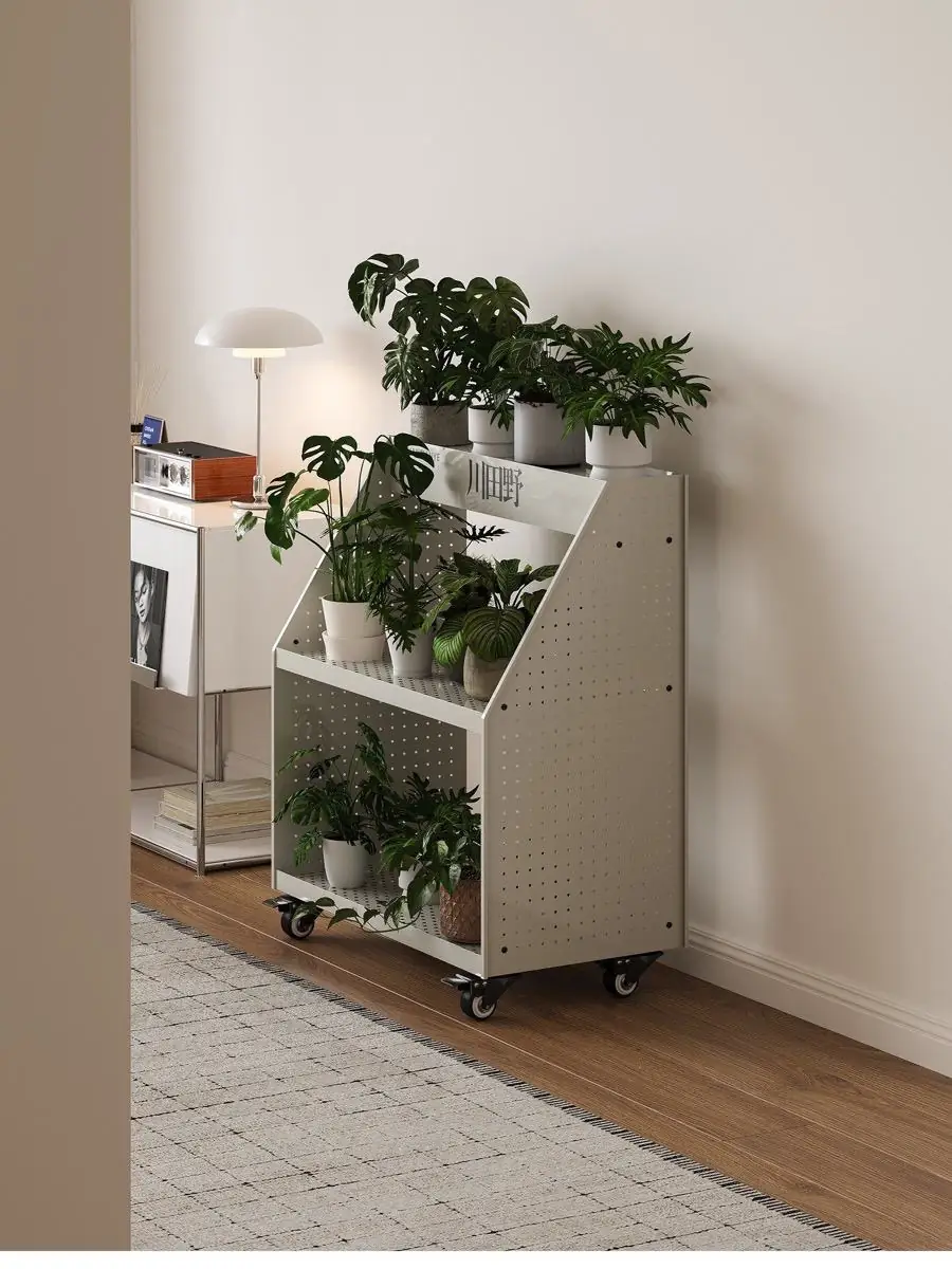 Close view of a potted plant on the perforated trolley shelf