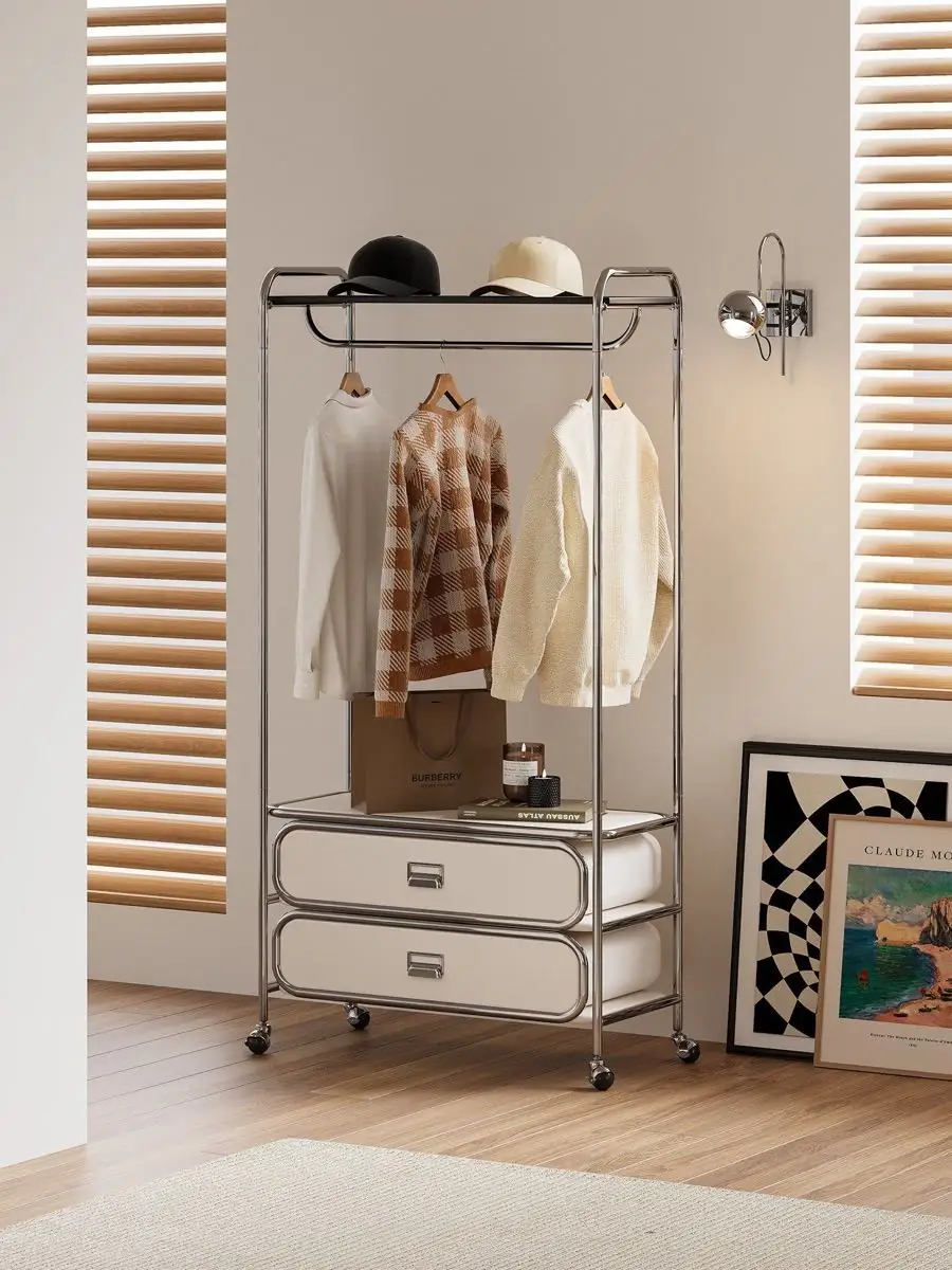 mobile tubular garment rack with drawers shown in a second interior setting