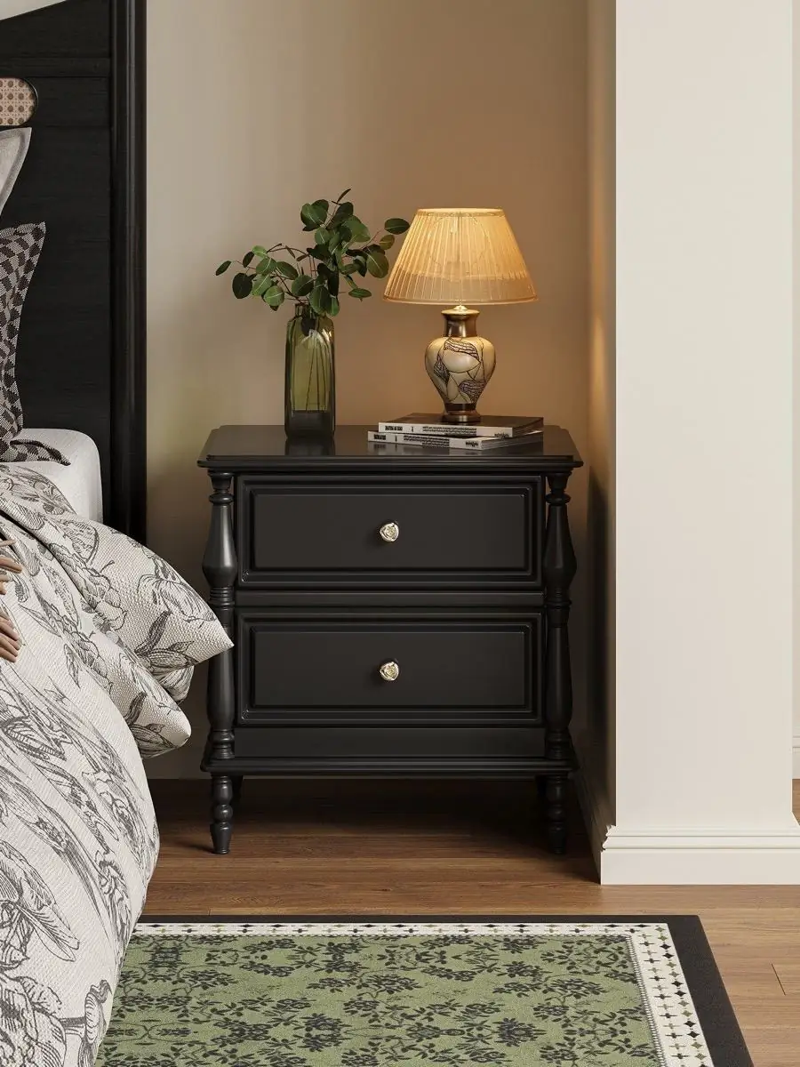 black classical-detail bedside cabinet presented in a styled residential interior