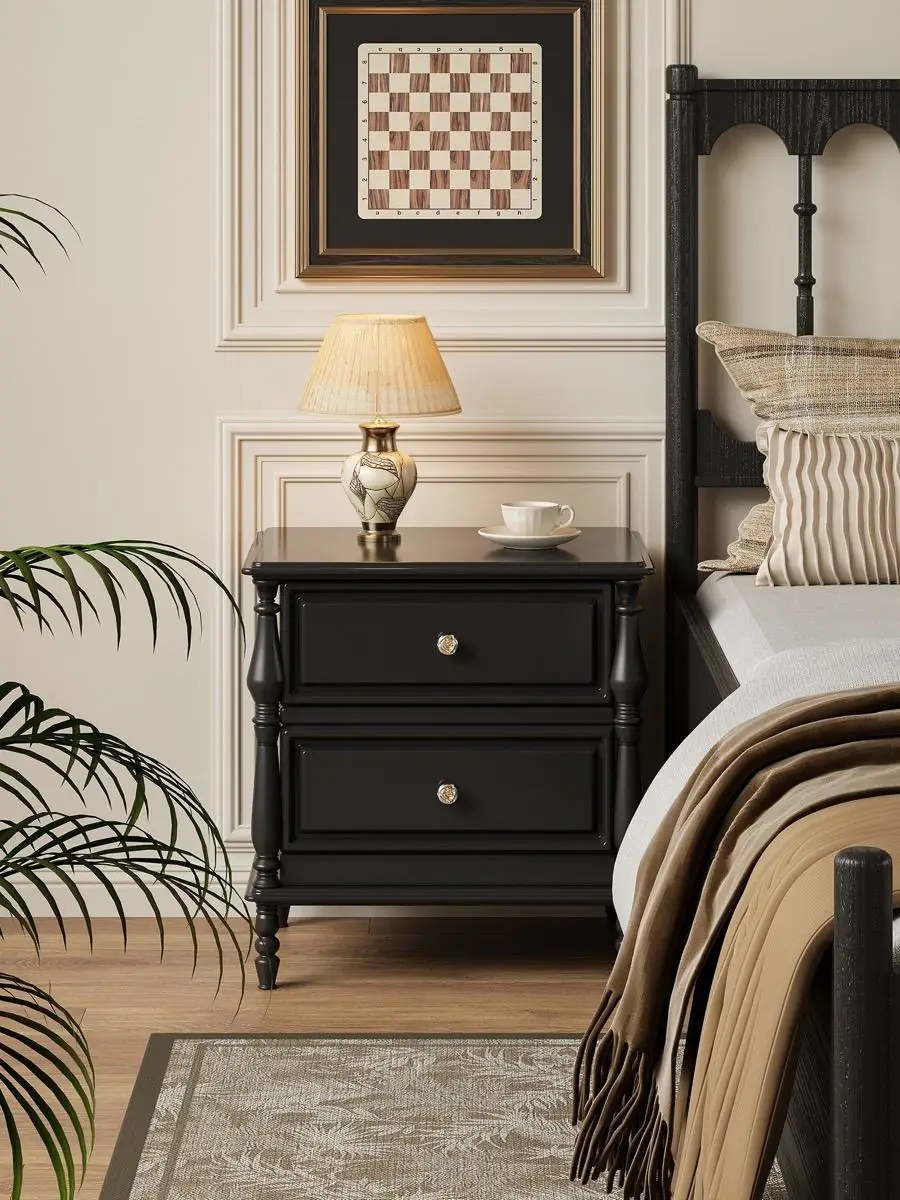 Alternate room view of the black classical-detail bedside cabinet