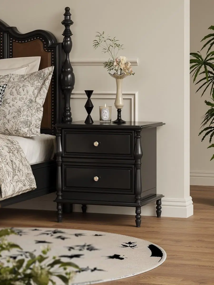 Material and form study of the black classical-detail bedside cabinet
