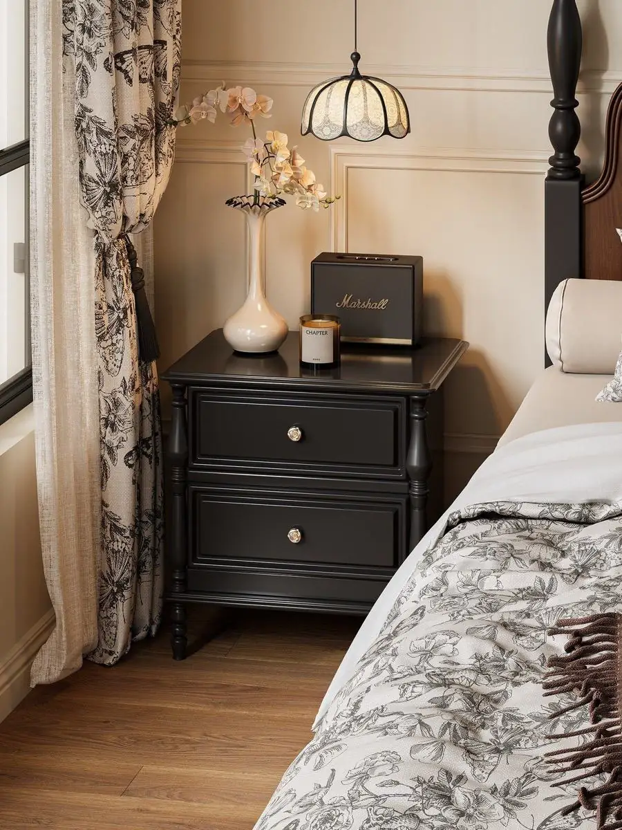 Final lifestyle view of the black classical-detail bedside cabinet