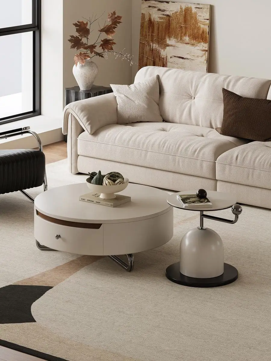 Cream table set centred on a pale rug in front of a sofa