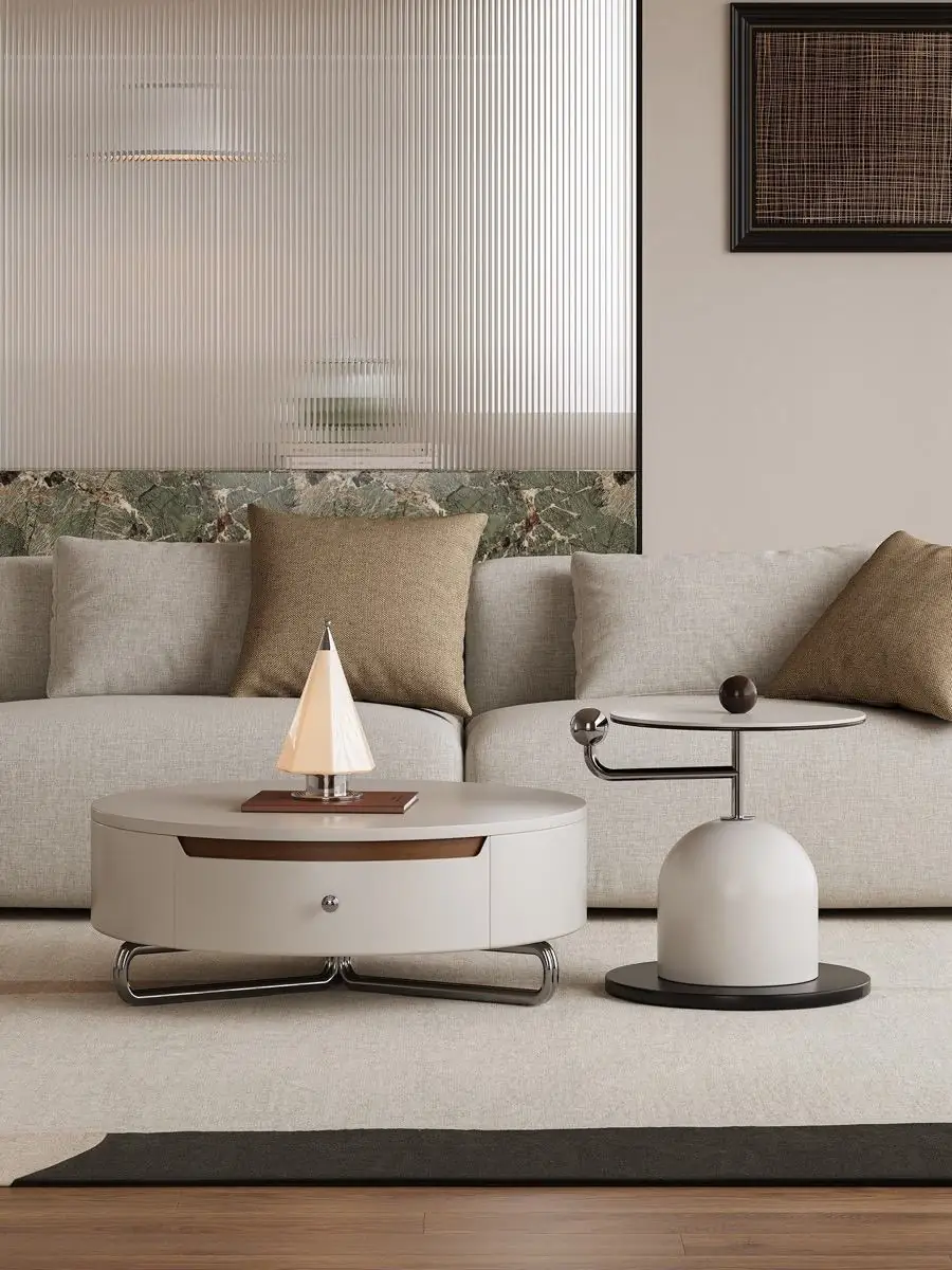 Cream coffee table and side table beside a sofa in warm daylight