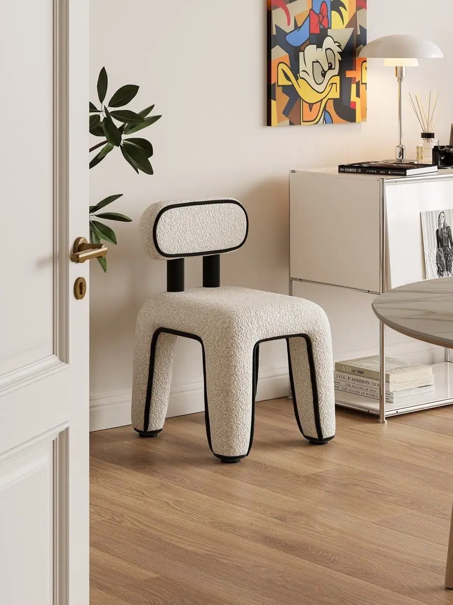 White accent chair beside a small metal table in a warm interior