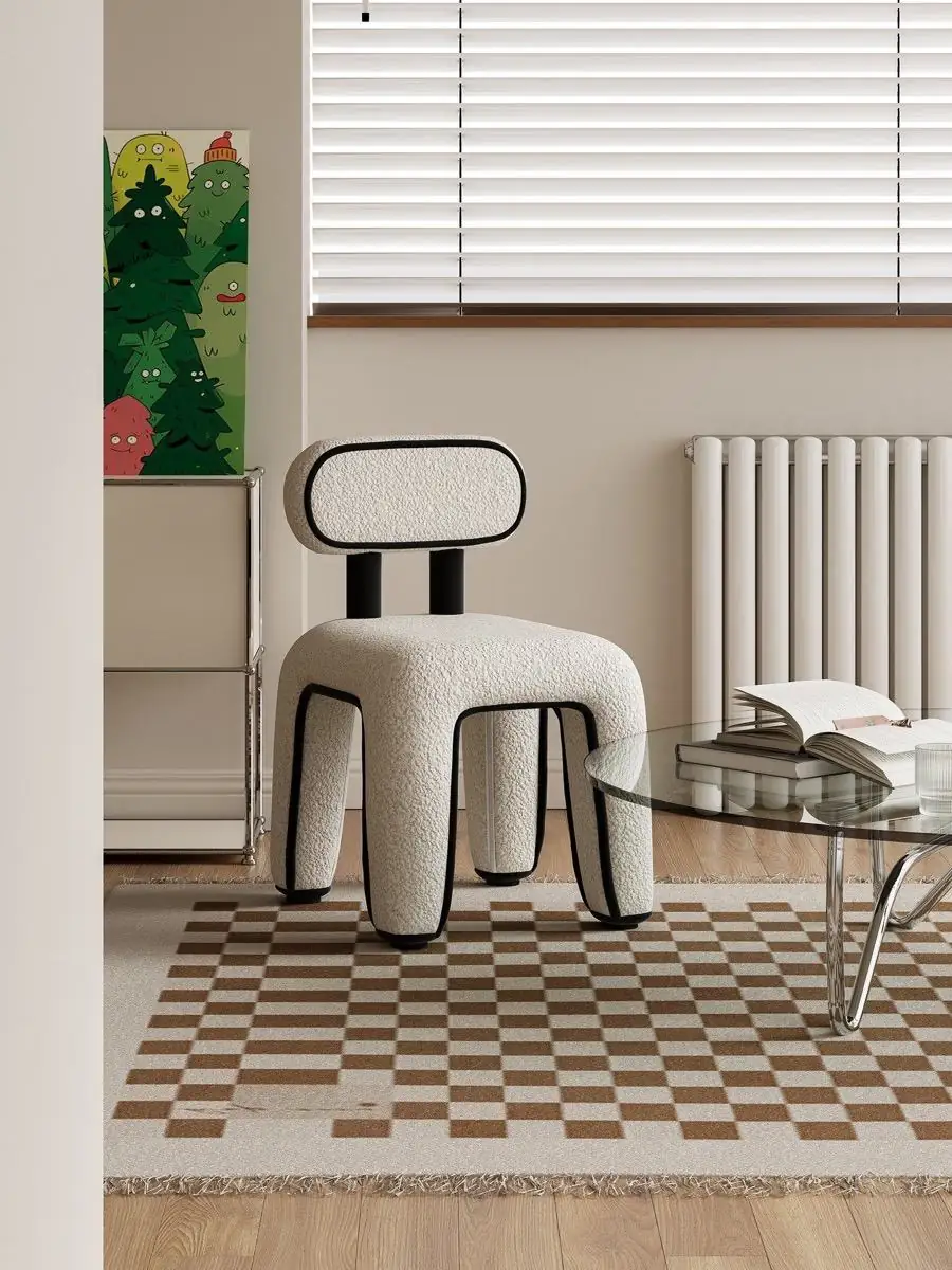 White bouclé chair centred on a patterned rug in soft daylight