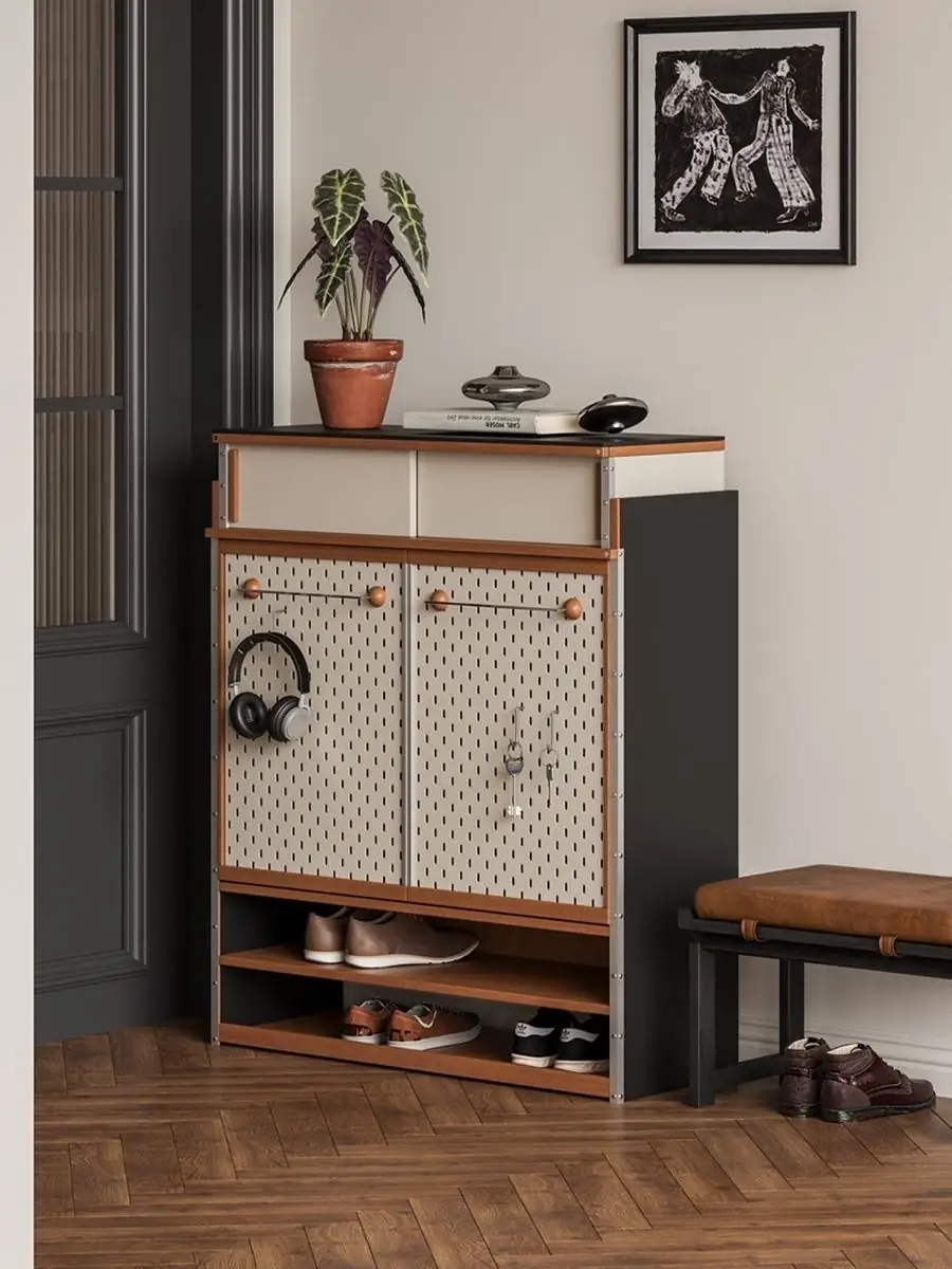 Vintage-inspired shoe cabinet with pale perforated doors and a dark timber frame