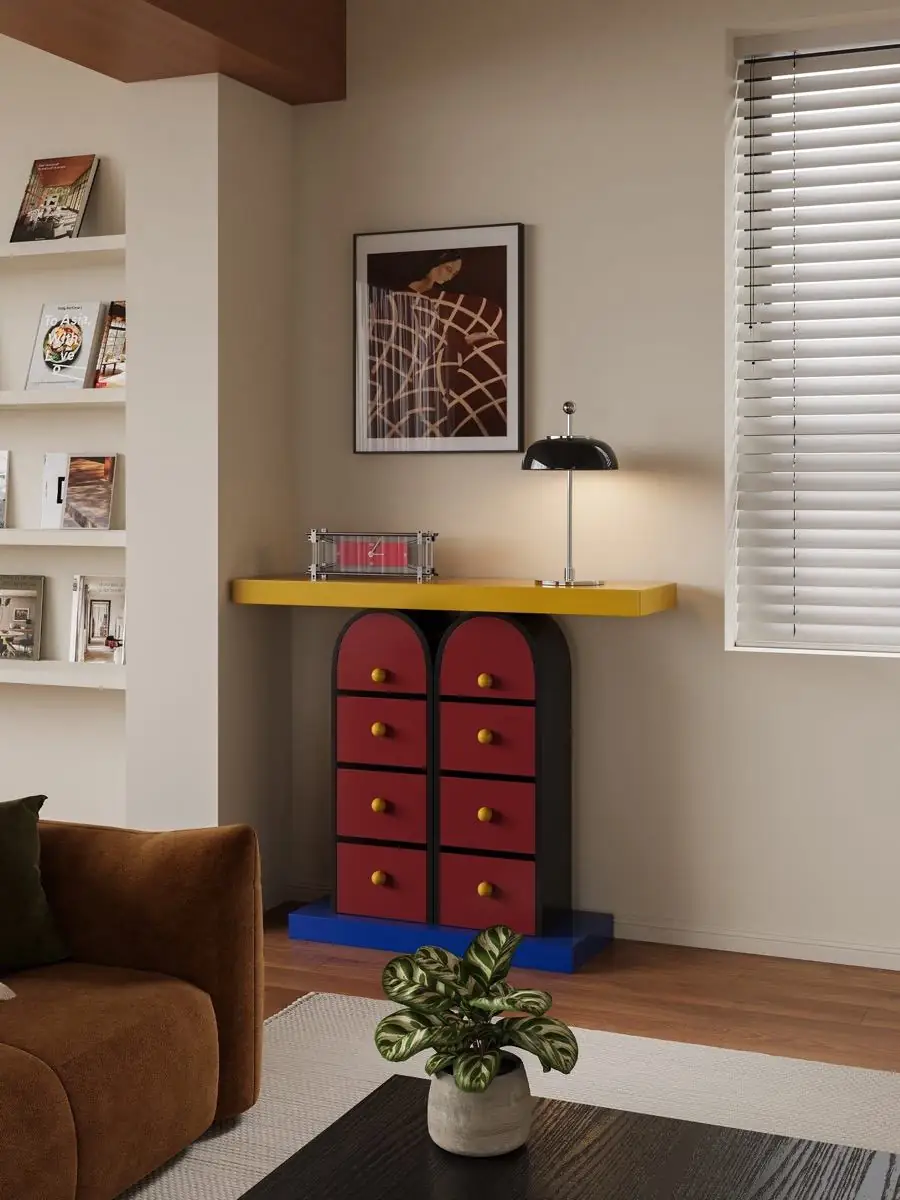 Memphis-style multicolour drawer console presented in a styled residential interior