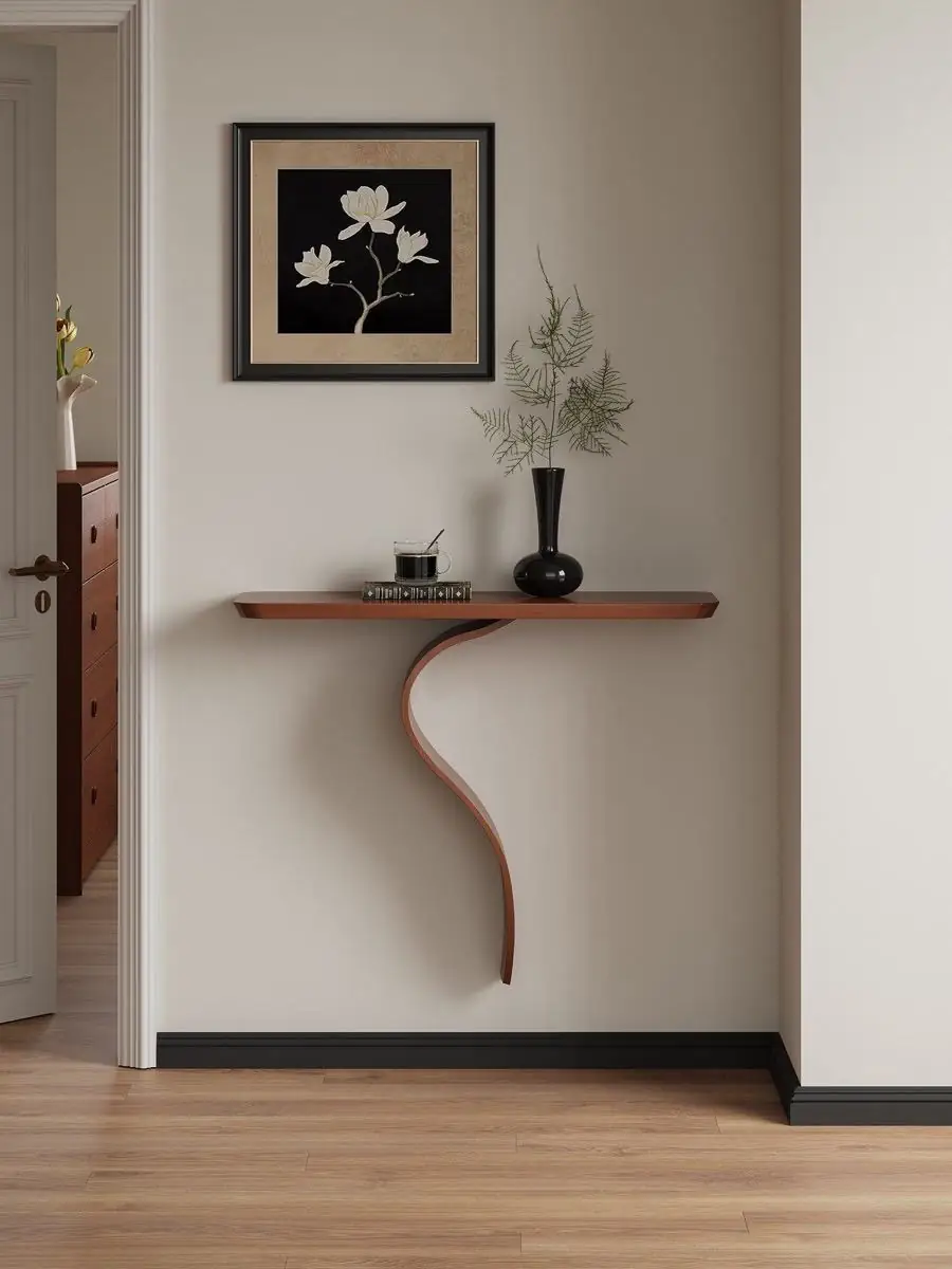 sculptural S-curve floating wall console presented in a styled residential interior