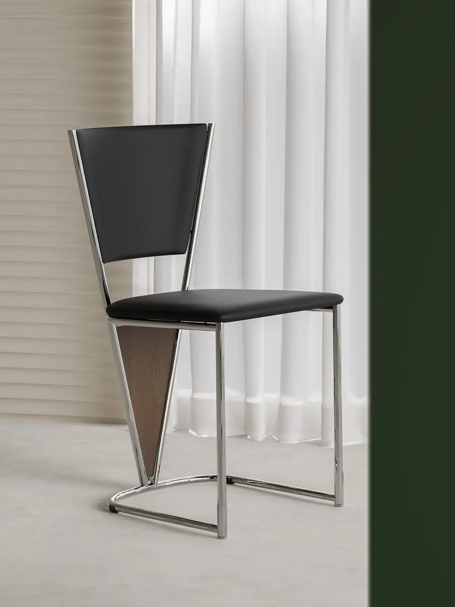 polished tubular-frame black dining chair presented in a styled residential interior