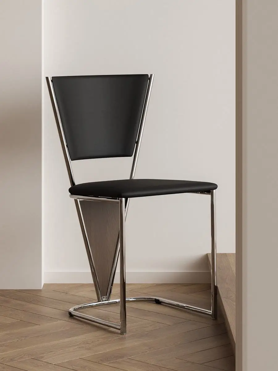 Alternate room view of the polished tubular-frame black dining chair