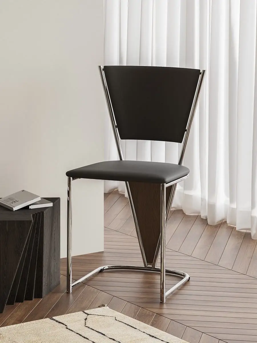 polished tubular-frame black dining chair shown in a second interior setting