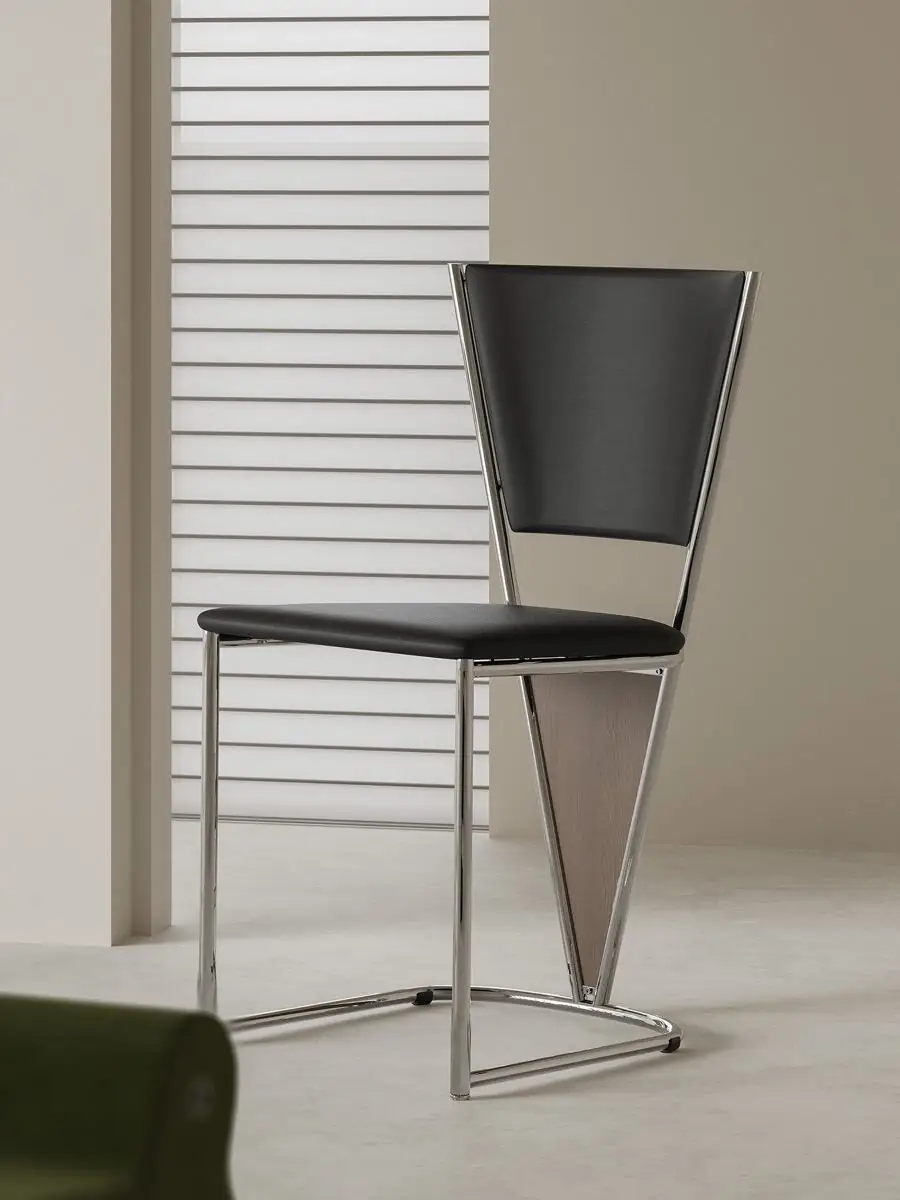 polished tubular-frame black dining chair shown with surrounding furniture for scale