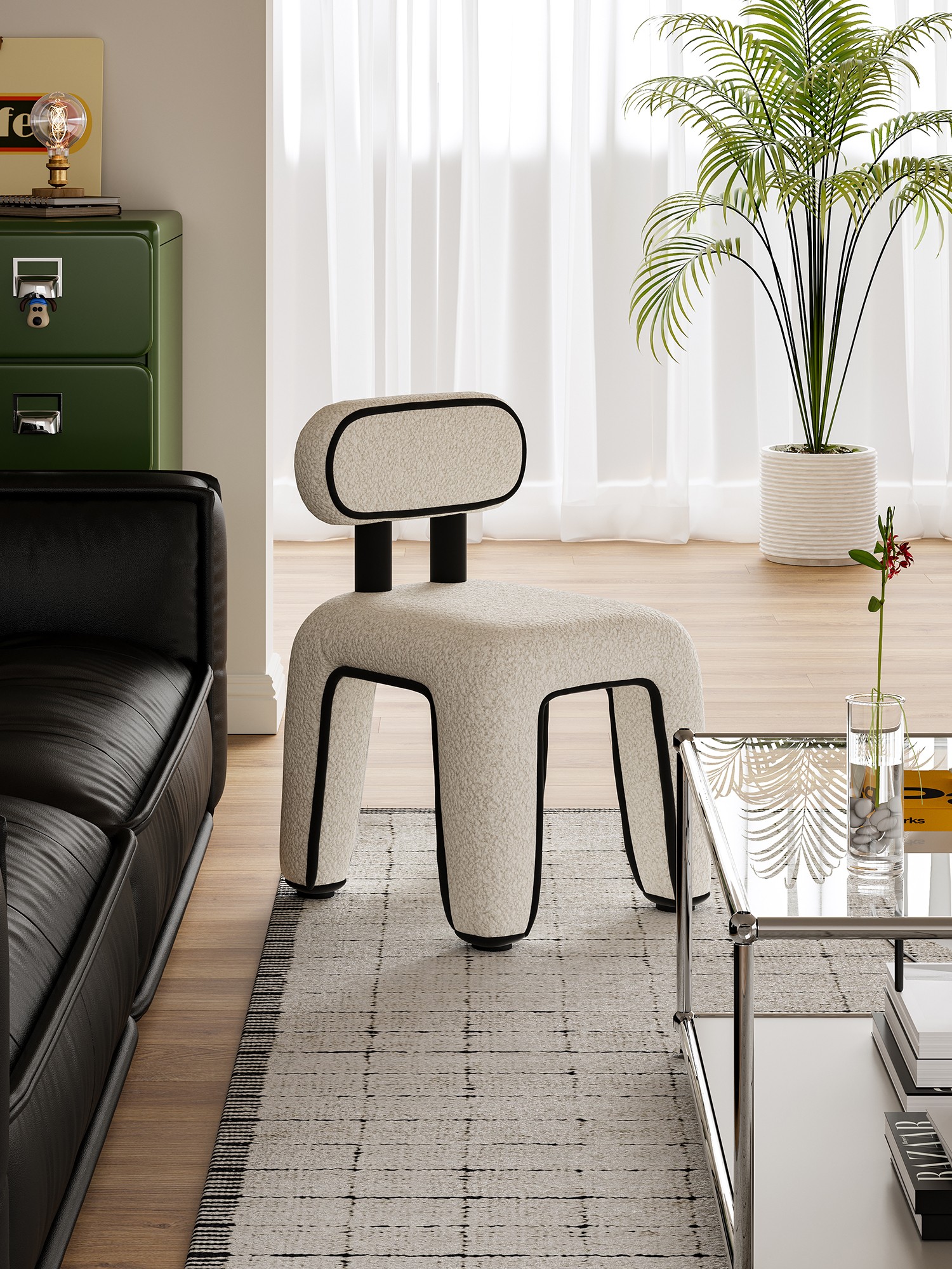 Front view of the piped bouclé chair beside a black leather sofa